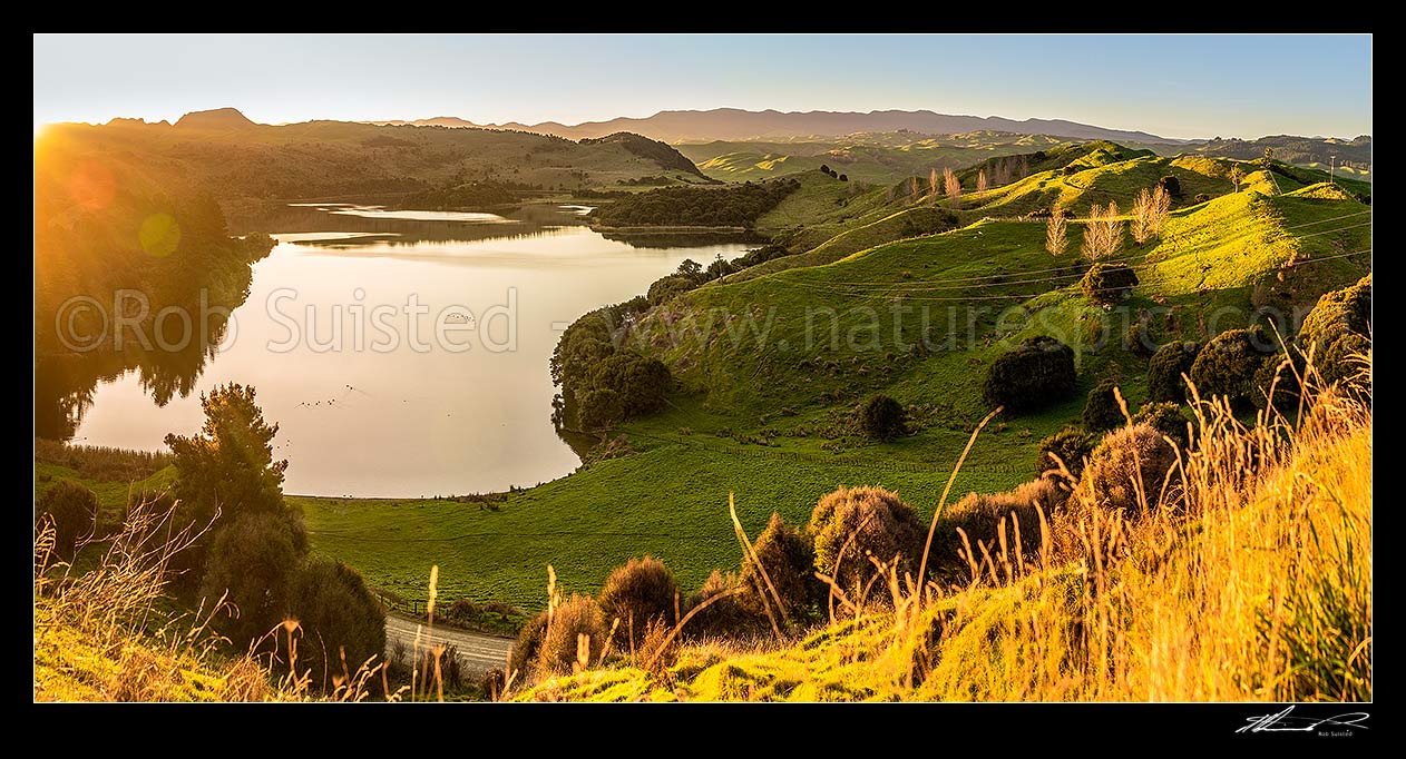 Image of Lake Rotonuiaha, nestled in northern Hawkes Bay farmland. Golden autumn colours and poplar trees at golden dusk. Panorama, Mohaka, Wairoa District, Hawke's Bay Region, New Zealand (NZ) stock photo image