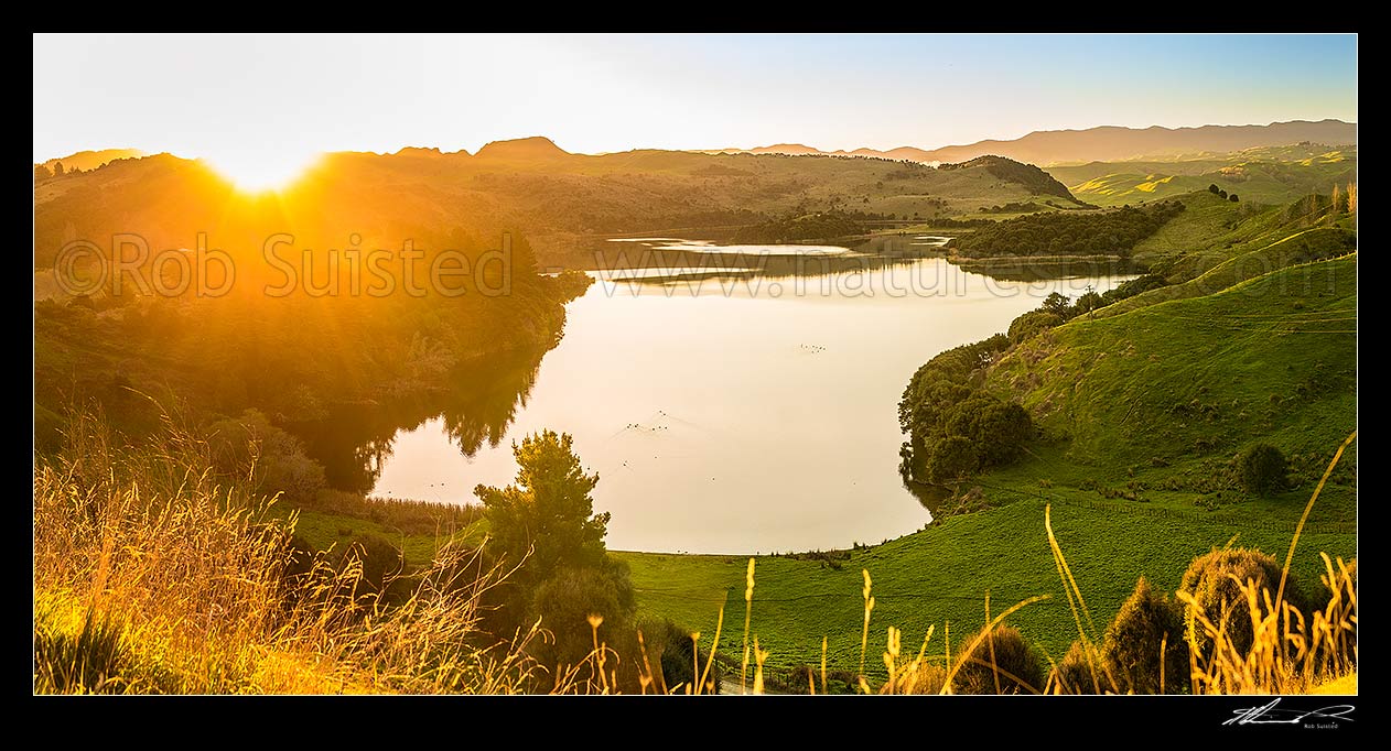 Image of Lake Rotonuiaha, nestled in northern Hawkes Bay farmland. Golden autumn colours and poplar trees at golden dusk. Panorama, Mohaka, Wairoa District, Hawke's Bay Region, New Zealand (NZ) stock photo image