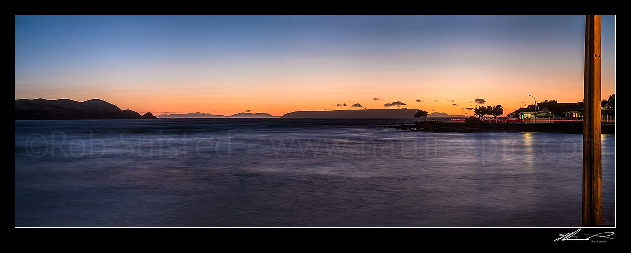 Image of Plimmerton Beach sunset. Titahi Bay coast at left, Mana Island centre right, and South Island in distance. Panorama, Plimmerton, Porirua City District, Wellington Region, New Zealand (NZ) stock photo image