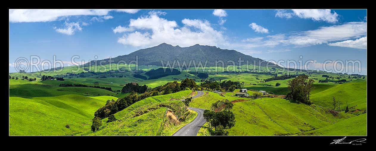 Image of Mount Karioi (756m) high above coastal Waikato farmland. Panorama over lush rural land, Raglan, Waikato District, Waikato Region, New Zealand (NZ) stock photo image