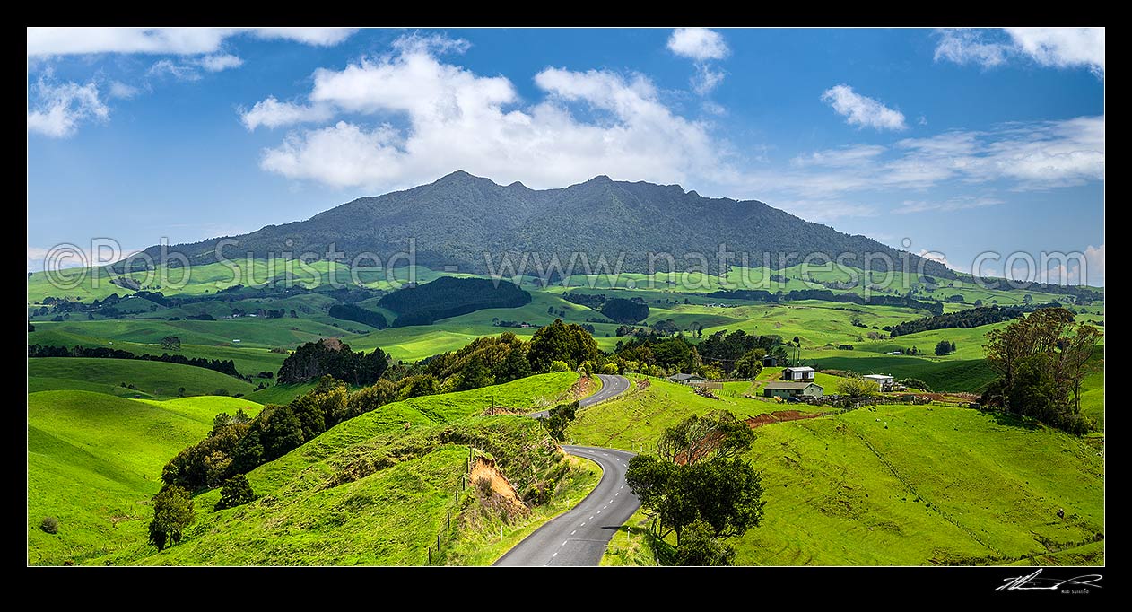 Image of Mount Karioi (756m) high above coastal Waikato farmland. Panorama over lush rural land, Raglan, Waikato District, Waikato Region, New Zealand (NZ) stock photo image