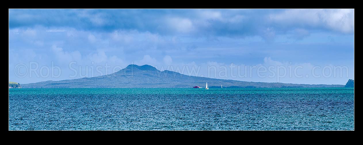 Image of Rangitoto Island seen across Tamaki Strait from Beachlands. Panorama with sailboat and ferry, Beachlands, Auckland Region, New Zealand (NZ) stock photo image