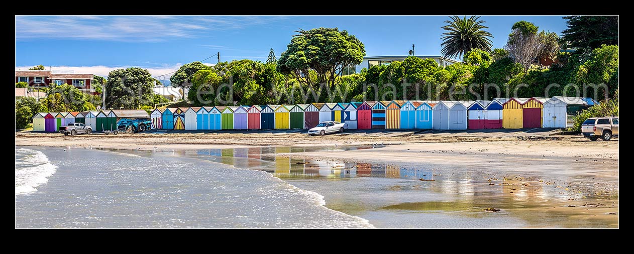 Image of Titahi Bay boatsheds, iconic brightly painted sheds on beach front at north end. Panorama, Titahi Bay, Porirua City District, Wellington Region, New Zealand (NZ) stock photo image