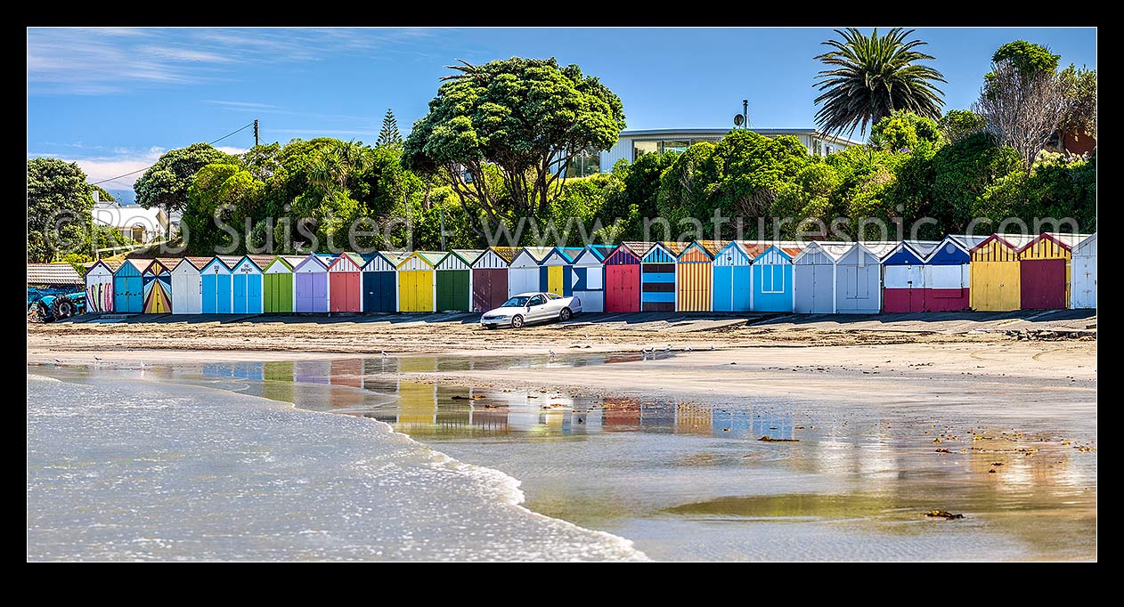 Image of Titahi Bay boatsheds, iconic brightly painted sheds on beach front at north end. Panorama, Titahi Bay, Porirua City District, Wellington Region, New Zealand (NZ) stock photo image