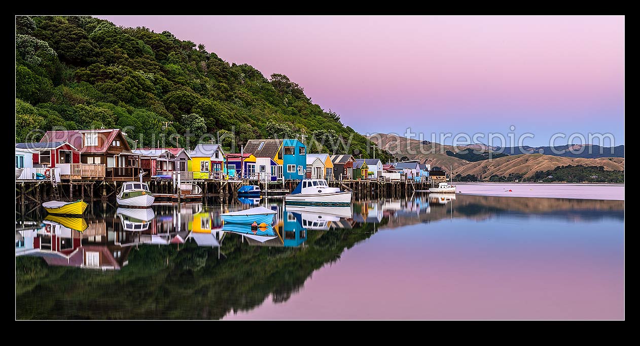 Image of Boatsheds at Mana on the Pauatahanui Arm Inlet of the Porirua Harbour, with boats on moorings. Evening twilight. Panorama, Paremata, Porirua City District, Wellington Region, New Zealand (NZ) stock photo image