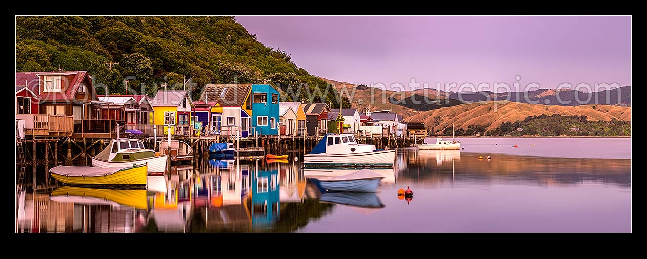 Image of Boatsheds at Mana on the Pauatahanui Arm Inlet of the Porirua Harbour, with boats on moorings. Evening twilight. Panorama, Paremata, Porirua City District, Wellington Region, New Zealand (NZ) stock photo image