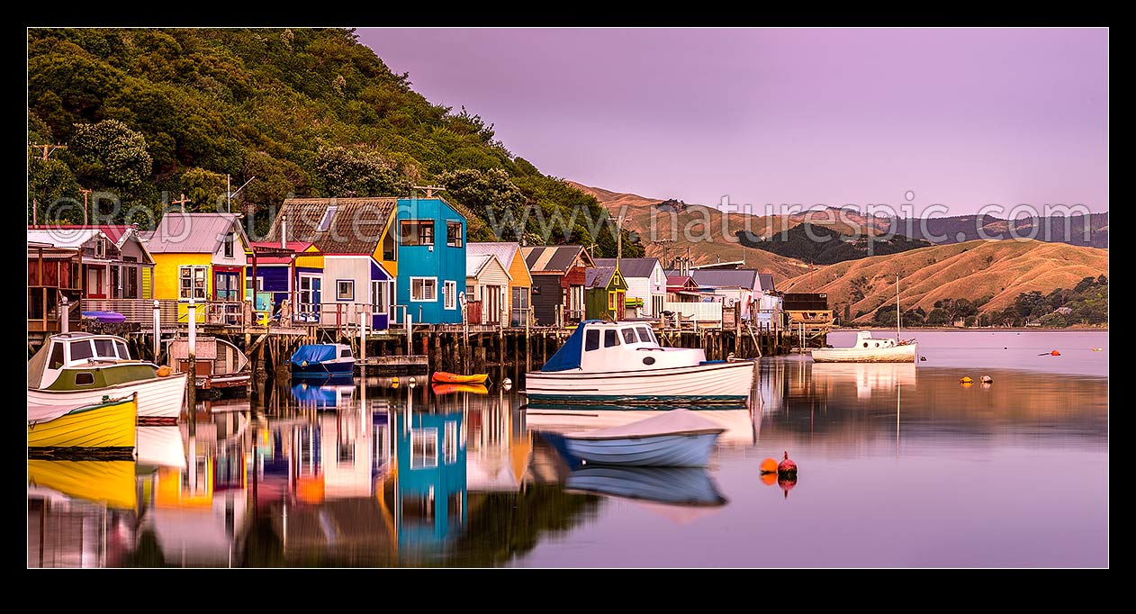 Image of Boatsheds at Mana on the Pauatahanui Arm Inlet of the Porirua Harbour, with boats on moorings. Evening twilight. Panorama, Paremata, Porirua City District, Wellington Region, New Zealand (NZ) stock photo image