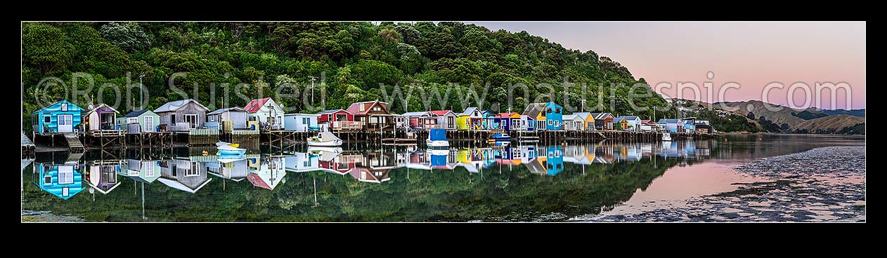 Image of Boatsheds at Mana on the Pauatahanui Arm Inlet of the Porirua Harbour, with boats on moorings. Evening twilight. Panorama, Paremata, Porirua City District, Wellington Region, New Zealand (NZ) stock photo image