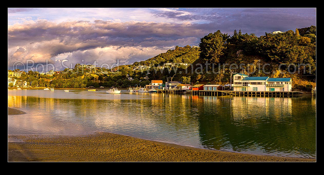 Image of Paremata boatsheds and moored vessels at Ivey Bay on Pauatahanui Inlet Arm of Porirua Harbour. Panorama, Paremata, Porirua City District, Wellington Region, New Zealand (NZ) stock photo image