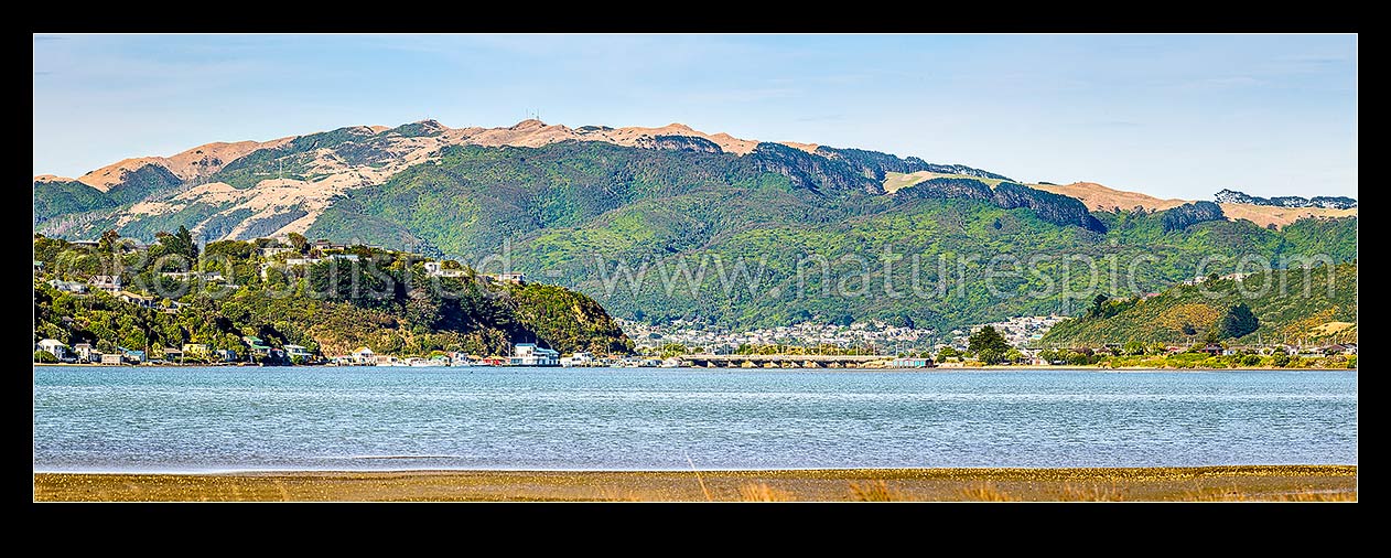 Image of Pauatahanui inlet of Porirua Harbour, seen from Grays Road. Looking to Paremata bridge, with Porirua City, Colonial Knob and Elsdon Bush behind. Panorama, Paremata, Porirua City District, Wellington Region, New Zealand (NZ) stock photo image