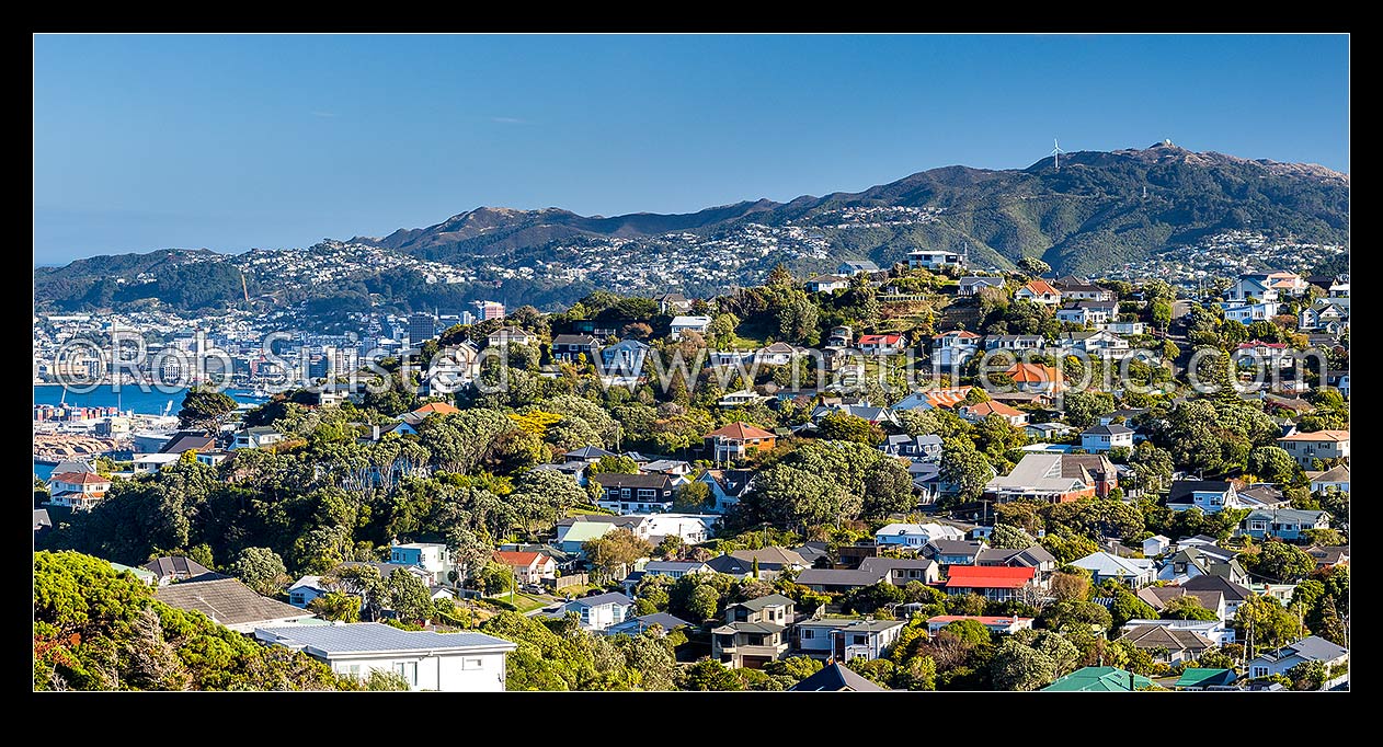 Image of Khandallah, a northern suburb of Wellington, with CBD visible at left. Brooklyn hill wind turbine visible above. Panorama, Kaiwharawhara, Wellington City District, Wellington Region, New Zealand (NZ) stock photo image