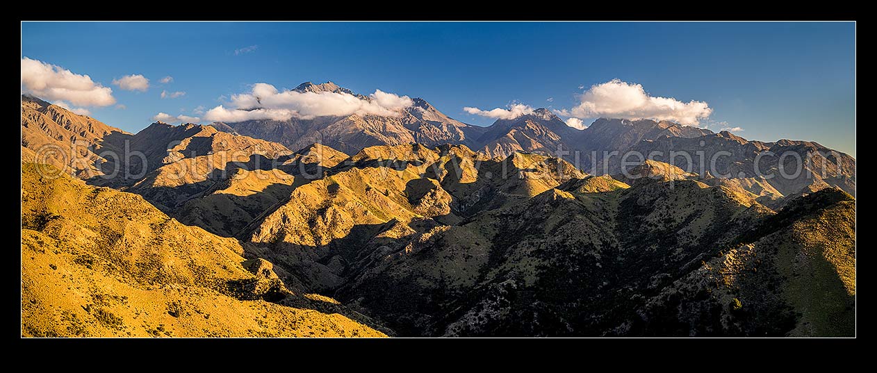 Image of Mt Tapuae-o-Uenuku (2885m) seen from the Cam River. Mt Alarm (2877m), Muzzle Pass, Mitre Peak (2621m), Trail Saddle and Mt Gladstone (in cloud) right. Panorama, Awatere Valley, Marlborough District, Marlborough Region, New Zealand (NZ) stock photo image