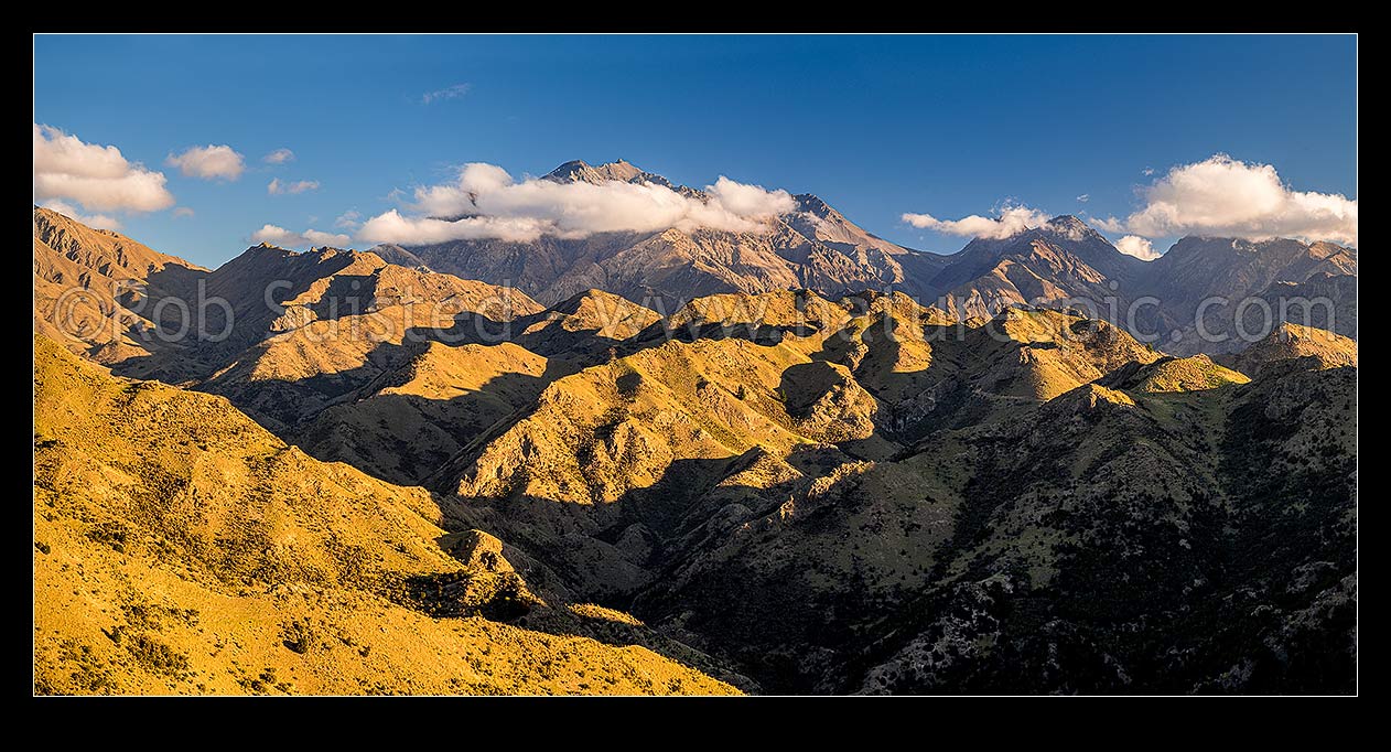 Image of Mt Tapuae-o-Uenuku (2885m) seen from the Cam River. Mt Alarm (2877m), Muzzle Pass, Mitre Peak (2621m), Trail Saddle and Mt Gladstone (in cloud) right. Panorama, Awatere Valley, Marlborough District, Marlborough Region, New Zealand (NZ) stock photo image