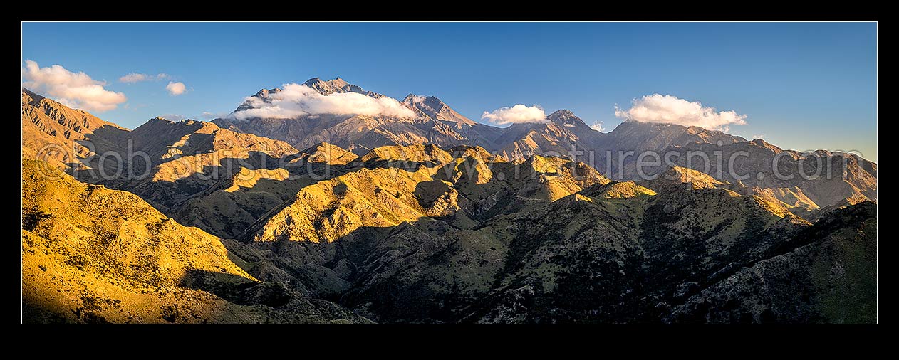 Image of Mt Tapuae-o-Uenuku (2885m) seen from the Cam River. Mt Alarm (2877m), Muzzle Pass, Mitre Peak (2621m), Trail Saddle and Mt Gladstone (in cloud) right. Panorama, Awatere Valley, Marlborough District, Marlborough Region, New Zealand (NZ) stock photo image