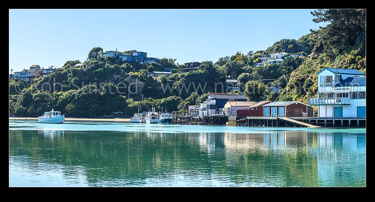 Image of Paremata boatsheds and boating club reflected at Ivey Bay on the Pauatahanui Inlet arm of Porirua Harbour. Panorama, Paremata, Porirua City District, Wellington Region, New Zealand (NZ) stock photo image