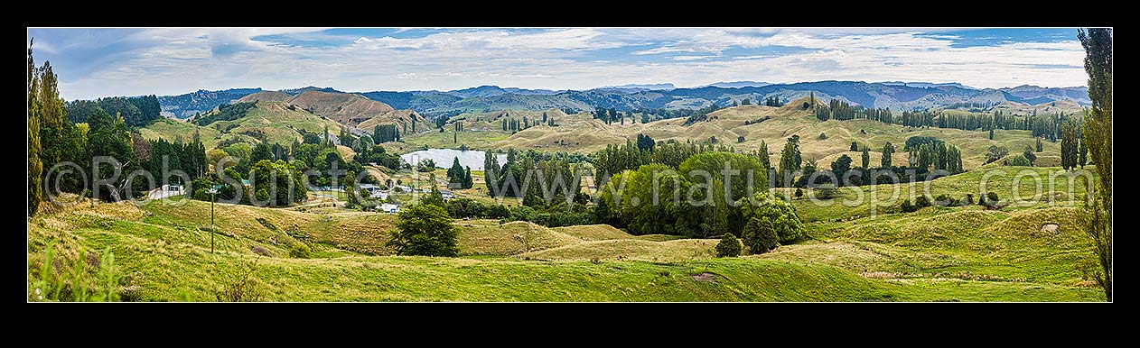 Image of Tiniroto village with Lake Rotokaha behind, on Tiniroto Road, inland Poverty Bay rural farming district. Panorama, Tiniroto, Gisborne District, Gisborne Region, New Zealand (NZ) stock photo image