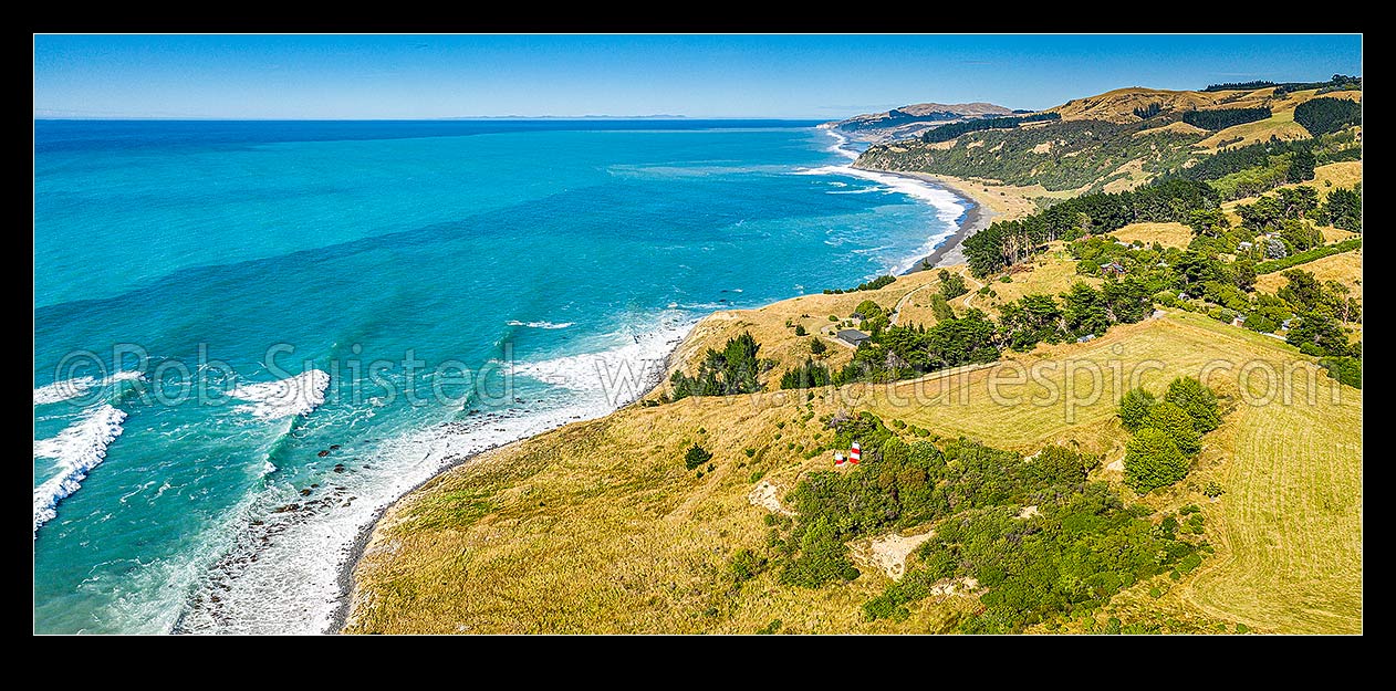 Image of Point Gibson lighthouse and navigation mark above Port Robinson, North Canterbury. Aerial panorama looking south past Manuka Bay towards Banks Peninsula on horizon, Gore Bay, Hurunui District, Canterbury Region, New Zealand (NZ) stock photo image