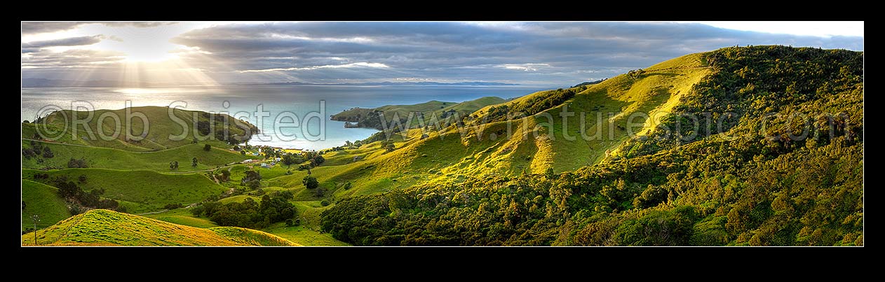 Image of Hauraki Gulf panorama. Moody sunshafts and clouds over sea near Kirita Bay, Coromandel Peninsula, looking towards Auckland. Stunning lush farmland panorama. Wider than 40436, Coromandel, Thames-Coromandel District, Waikato Region, New Zealand (NZ) stock photo image