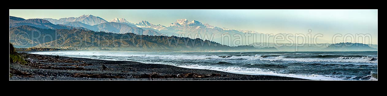 Image of Aoraki Mt Cook (3754m) and Mt Tasman (3497m) centre with Southern Alps Main Divide towering over Westland beach near Hokitika, at dawn. Ross at left. Panorama, Hokitika, Westland District, West Coast Region, New Zealand (NZ) stock photo image