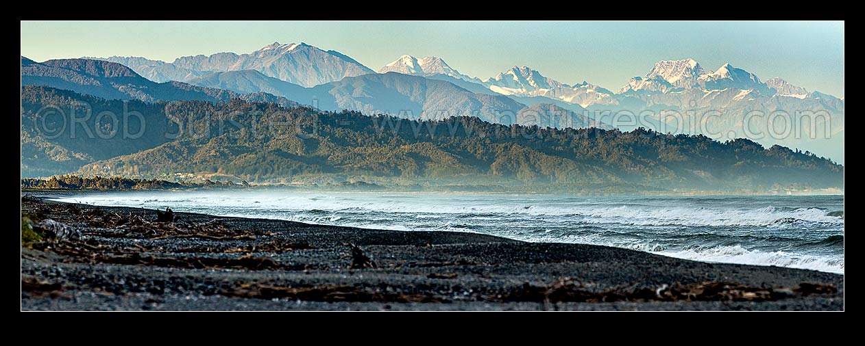 Image of Aoraki Mt Cook (3754m) and Mt Tasman (3497m) right with Southern Alps above Westland beach near Hokitika at dawn. Mt Elie De Beaumont (3109m) centre. Panorama, Hokitika, Westland District, West Coast Region, New Zealand (NZ) stock photo image