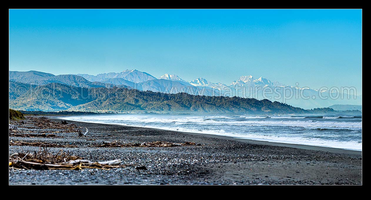 Image of Southern Alps Main Divide above Westland beach near Hokitika, at dawn. Aoraki Mt Cook (3754m) and Mt Tasman (3497m) centre right, Mt Adams (2208m) left. Panorama, Hokitika, Westland District, West Coast Region, New Zealand (NZ) stock photo image