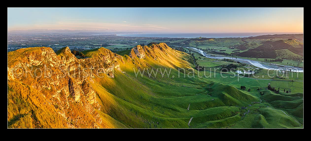 Image of Sunrise on Te Mata Peak (399m). Overlooking Hawke Bay and the Tukituki River with Napier far left. Panorama, Hawkes Bay, Hastings District, Hawke's Bay Region, New Zealand (NZ) stock photo image