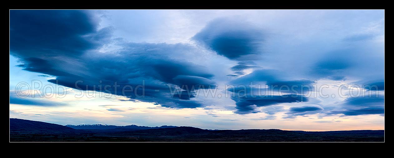 Image of Clouds over Central Otago. Moody dramatic lenticular clouds at dawn. Panorama, Middlemarch, Central Otago District, Otago Region, New Zealand (NZ) stock photo image