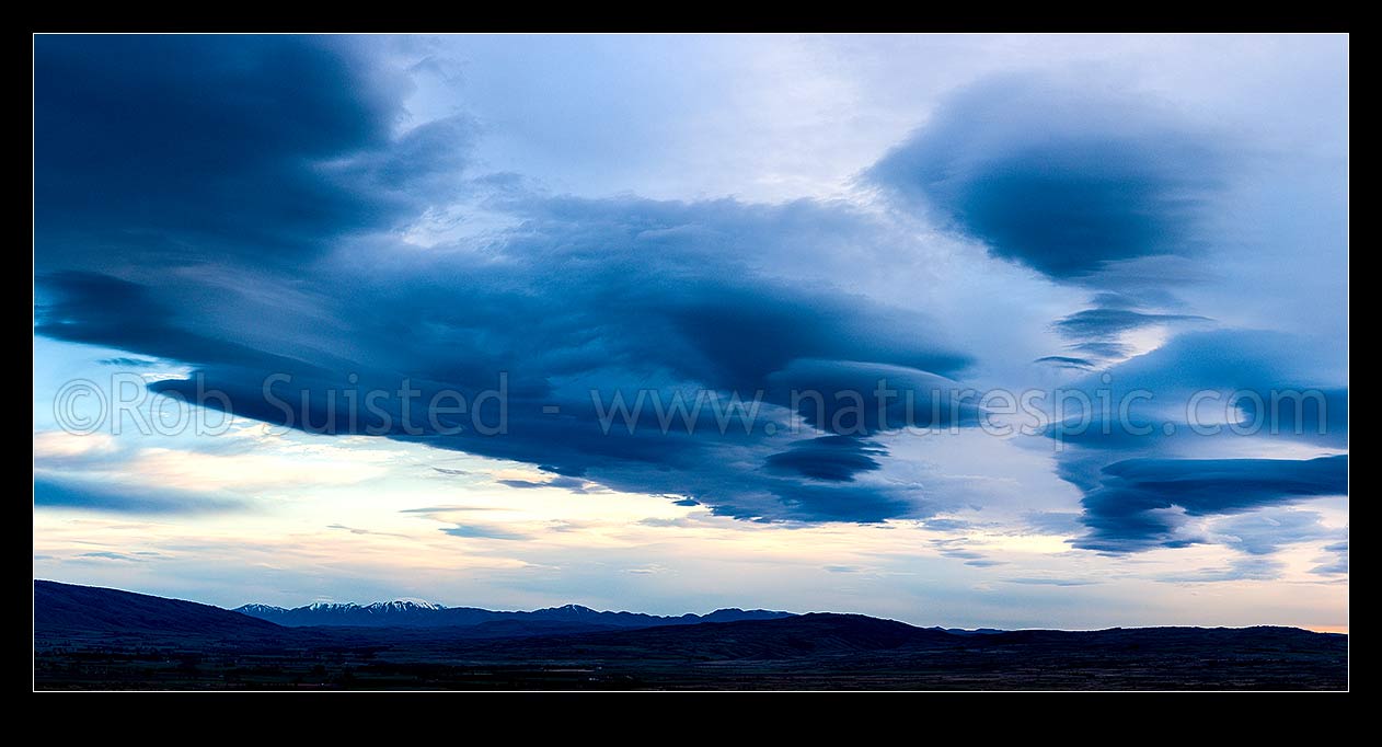 Image of Clouds over Central Otago. Moody dramatic lenticular clouds at dawn. Panorama, Middlemarch, Central Otago District, Otago Region, New Zealand (NZ) stock photo image