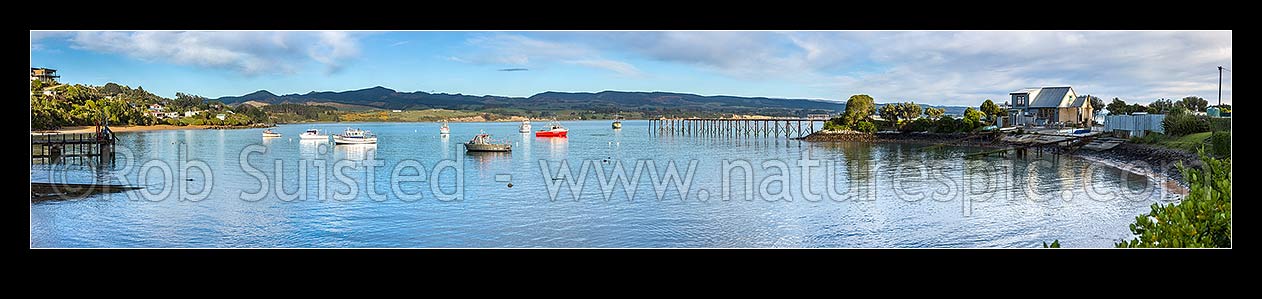 Image of Moeraki fishing fleet boats moored in Onekakara Bay on a calm morning. Panorama, Moeraki, Waitaki District, Canterbury Region, New Zealand (NZ) stock photo image