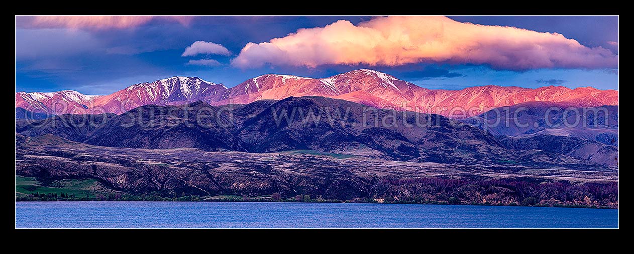 Image of Lake Aviemore with the sunlit Kirkliston Range above. High country panorama at sunset, Otematata, MacKenzie District, Canterbury Region, New Zealand (NZ) stock photo image