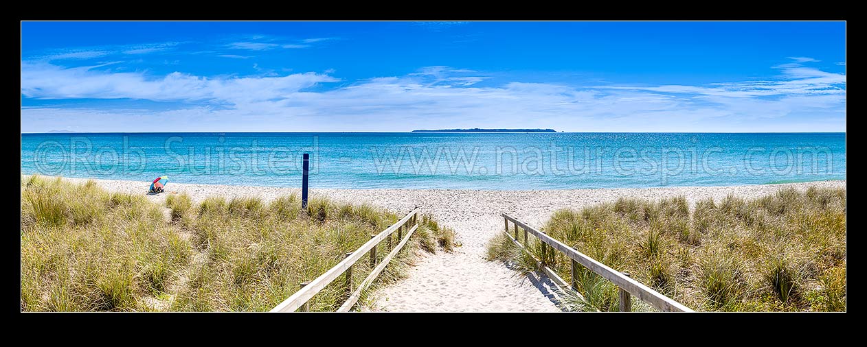 Image of Papamoa Beach, looking down sand hill access path to white sand beach, with Motiti Island beyond. Lone beach goer with sun umbrella. Panorama, Papamoa Beach, Tauranga District, Bay of Plenty Region, New Zealand (NZ) stock photo image