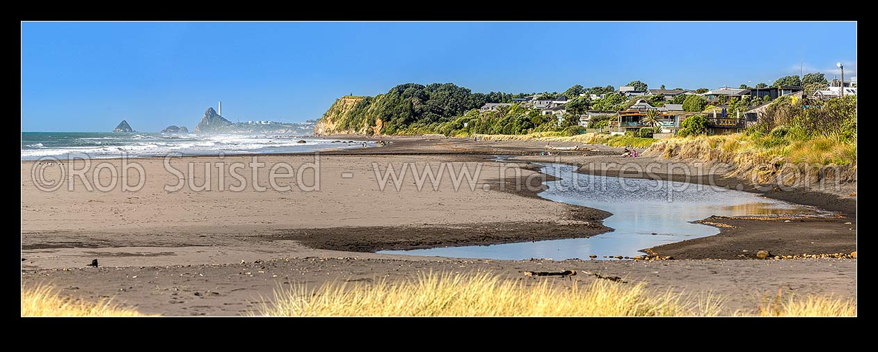 Image of Oakura Beach front and Waimoku Stream. Nga Motu Sugar Loaf Islands, Paritutu Rock (154m) and distinctive power station chimney behind. Panorama, Oakura, New Plymouth District, Taranaki Region, New Zealand (NZ) stock photo image