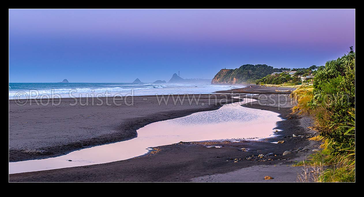 Image of Oakura Beach & Waimoku Stream on a calm moody twilight. Nga Motu Sugar Loaf Islands, Paritutu Rock (154m) and power station chimney behind. Panorama, Oakura, New Plymouth District, Taranaki Region, New Zealand (NZ) stock photo image