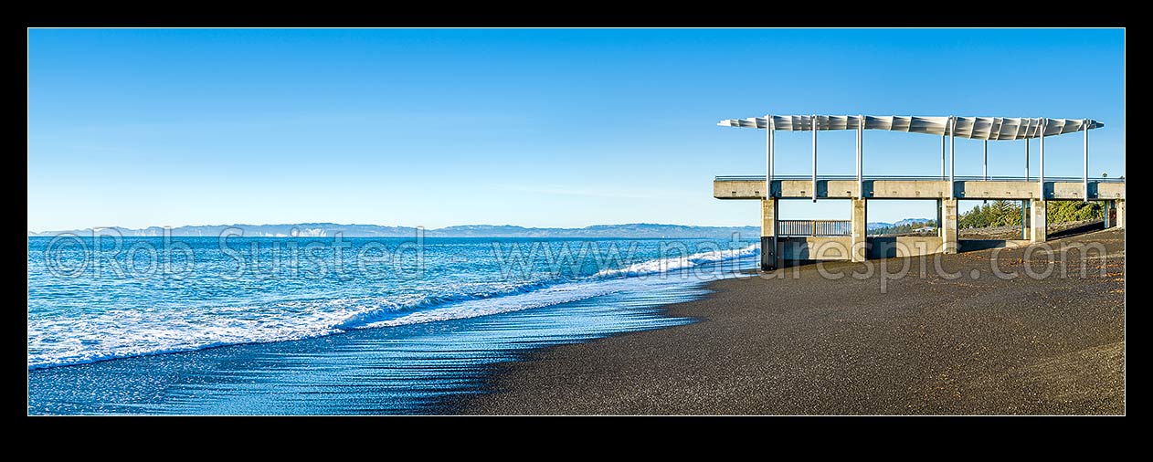 Image of Napier foreshore with viewing platform and marine outfall in early morning light. Clifton and Cape Kidnappers coast beyond. Panorama, Napier, Napier City District, Hawke's Bay Region, New Zealand (NZ) stock photo image