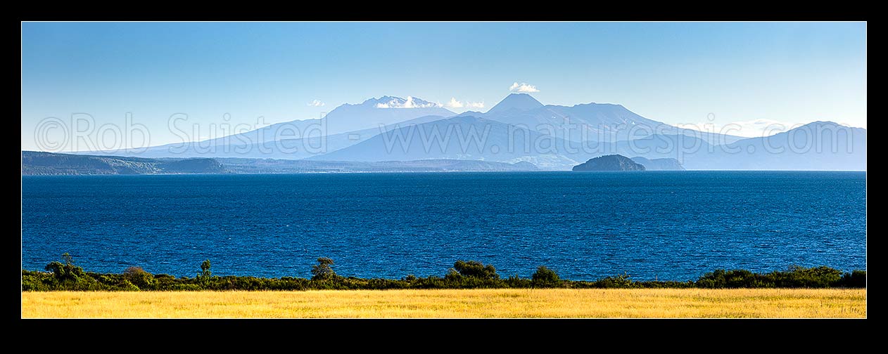 Image of Lake Taupo, looking south to volcanic central plateau, Tongariro National park and Mountains Ruapehu, Ngauruhoe and Tongariro. Motutaiko Island right. Panorama, Taupo, Taupo District, Waikato Region, New Zealand (NZ) stock photo image