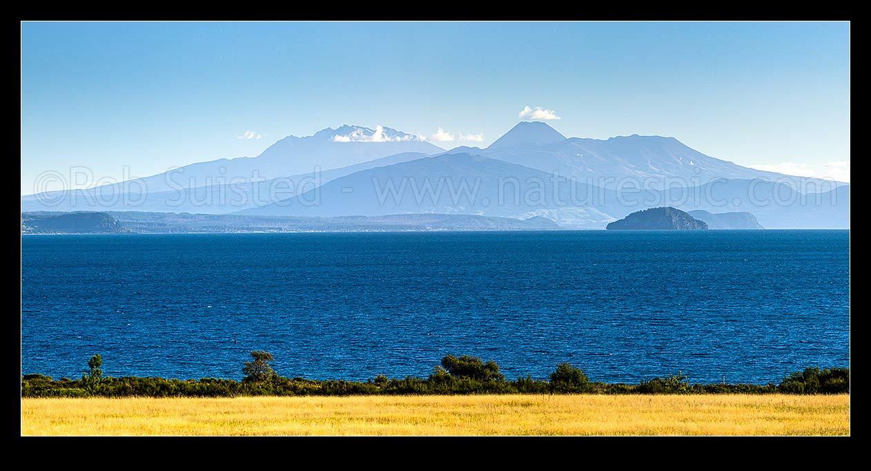 Image of Lake Taupo, looking south to volcanic central plateau, Tongariro National park and Mountains Ruapehu, Ngauruhoe and Tongariro. Motutaiko Island right. Panorama, Taupo, Taupo District, Waikato Region, New Zealand (NZ) stock photo image