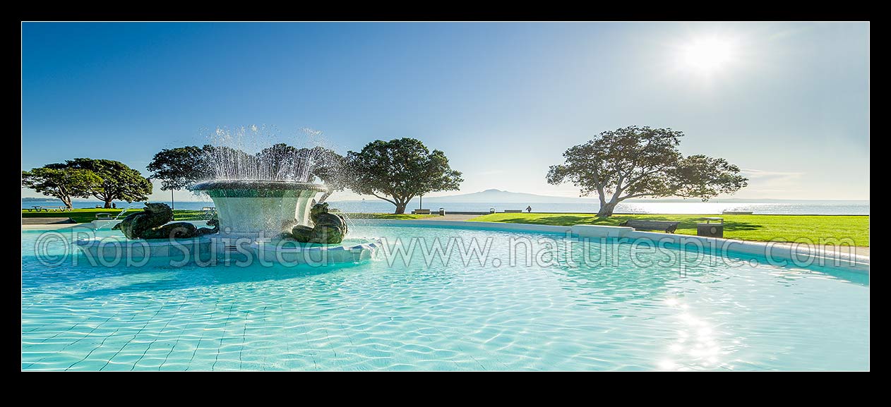 Image of Mission Bay Fountain, art deco design fountain given to the citizens of Auckland in 1950. Rangitoto Island behind. Adapted to wide format from 52418TC00, Mission Bay, Auckland City District, Auckland Region, New Zealand (NZ) stock photo image