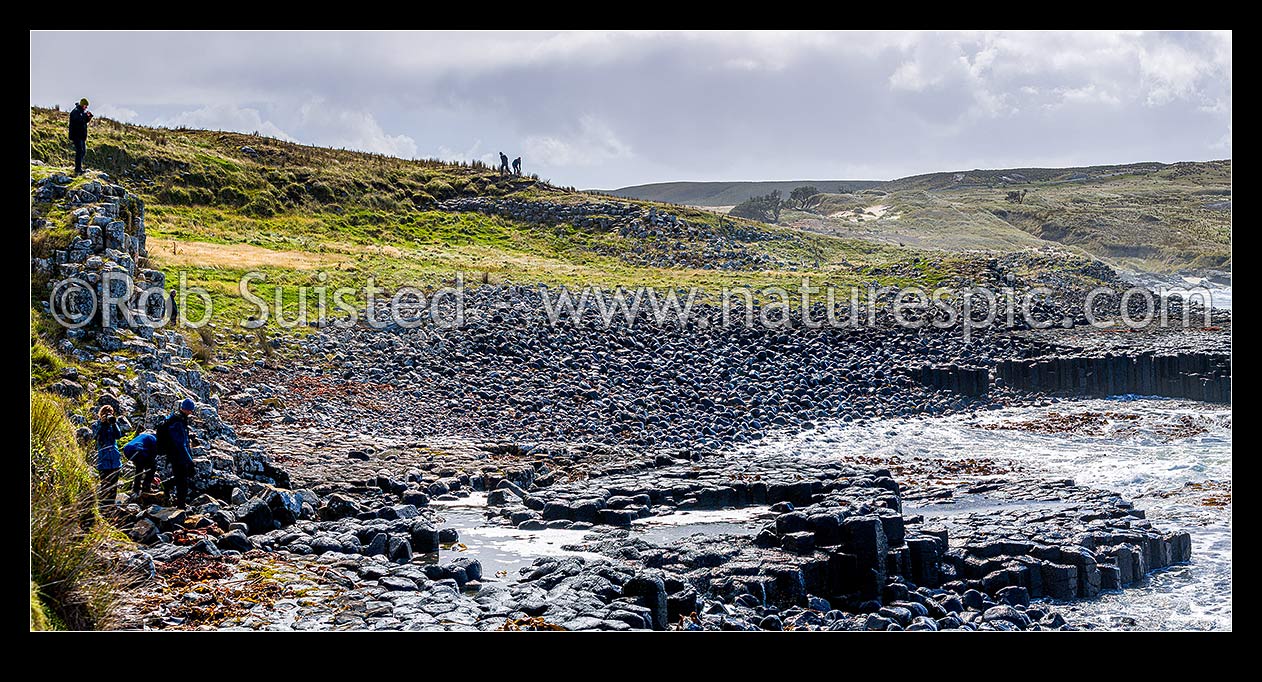 Image of Ohira Bay basalt columns in Petre Bay, with visitors visiting on a typically windy day on Rekohu. Panorama view, Chatham Islands Rekohu, Chatham Islands District, Chatham Islands Region, New Zealand (NZ) stock photo image