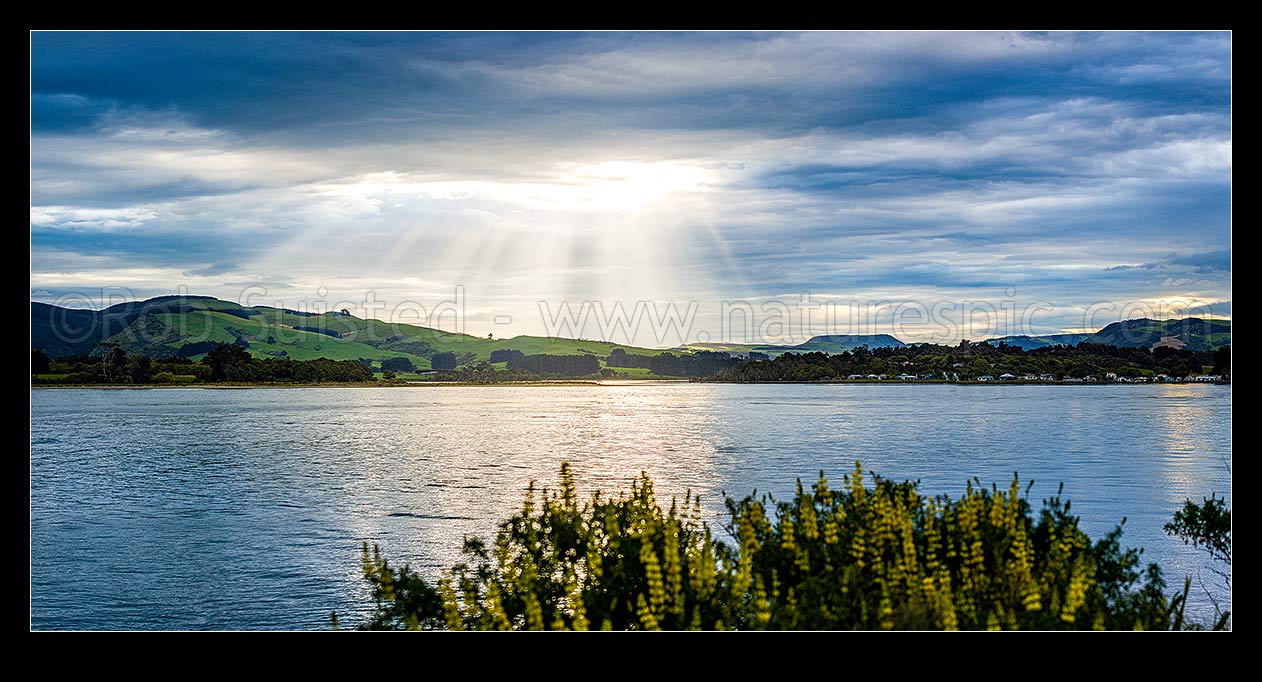 Image of Catlins River mouth at Surat Bay and New Haven, with sunrays over the inlet. Panorama, Catlins, Clutha District, Otago Region, New Zealand (NZ) stock photo image