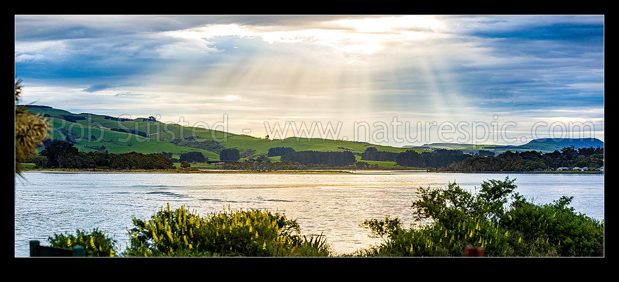 Image of Catlins River mouth at Surat Bay and New Haven, with sunrays over the inlet. Panorama, Catlins, Clutha District, Otago Region, New Zealand (NZ) stock photo image