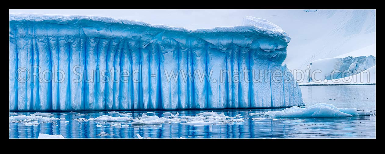 Image of Iceberg in Antarctica showing vertical striations pattern caused by melt air bubble fluting. Polar panorama, Antarctic Peninsula, Antarctica Region, New Zealand (NZ) stock photo image