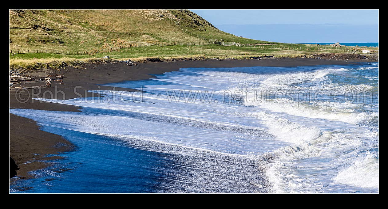 Image of Te Awaiti surf and waves rolling into the Oterei River Mouth at Tora beach. Te Awaiti Station beyond, Tora, South Wairarapa District, Wellington Region, New Zealand (NZ) stock photo image