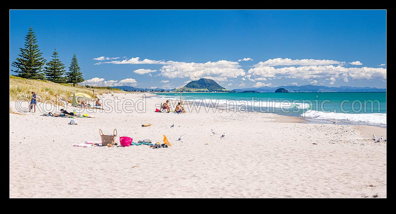 Image of Papamoa Beach on a summer day with people enjoying the summer sunshine. Looking west towards Mt Maunganui Mauao (231m). Panorama, Papamoa Beach, Tauranga District, Bay of Plenty Region, New Zealand (NZ) stock photo image