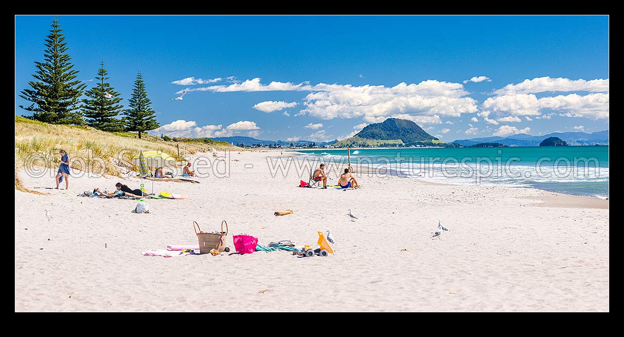 Image of Papamoa Beach on a summer day with people enjoying the summer sunshine. Looking west towards Mt Maunganui Mauao (231m). Panorama, Papamoa Beach, Tauranga District, Bay of Plenty Region, New Zealand (NZ) stock photo image